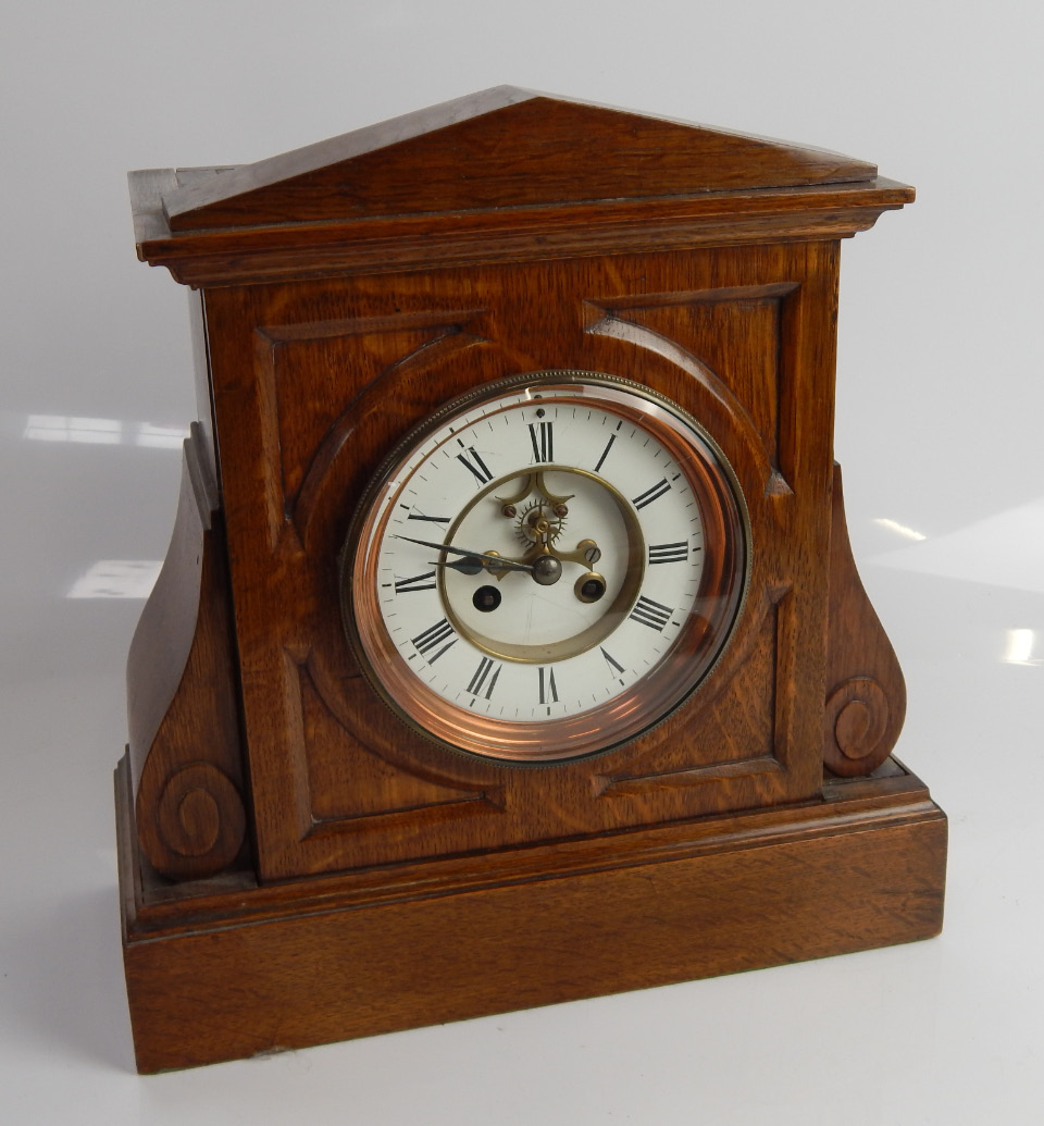 Appraisal: A late Victorian oak mantel clock with two part enamelled