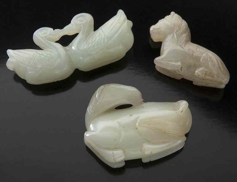 Appraisal: Chinese Qing carved jade togglesdepicting horses and a double duck