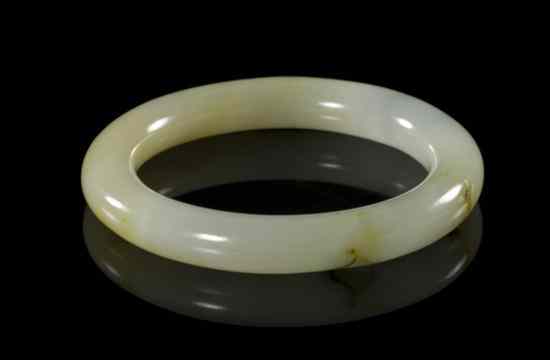 Appraisal: A Jade Bangle of a pale yellow stone with russet