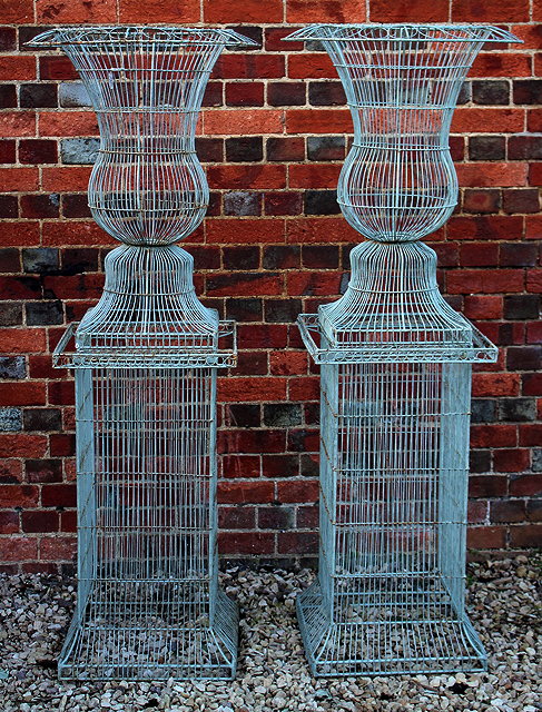 Appraisal: A PAIR OF WIREWORK URNS of narrow campana form and