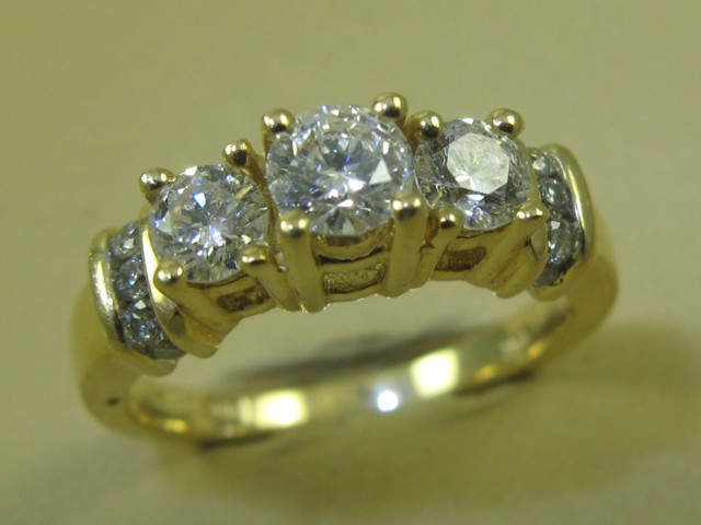 Appraisal: DIAMOND AND FOURTEEN KARAT GOLD RING set with three round