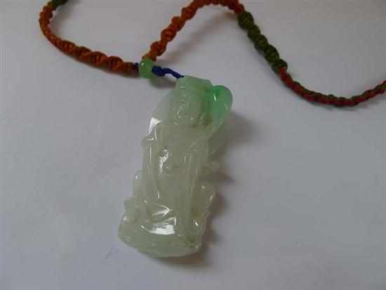 Appraisal: A CARVED JADE PENDANT ON A MULTI COLOURED CORD