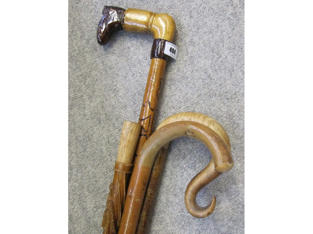 Appraisal: Lot comprising three shepherds crooks and a carved walking stick