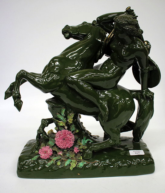 Appraisal: A CONTINENTAL PORCELAIN GREEN GLAZED REARING HORSE with semi clad