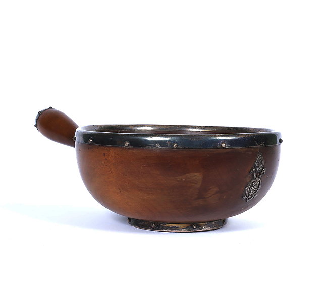 Appraisal: A VICTORIAN SILVER MOUNTED TURNED WOODEN ALMS BOWL in the