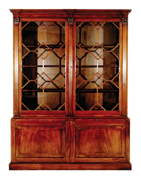 Appraisal: Edwardian carved mahogany bookcase circa dentil-molded and stepped cornice above