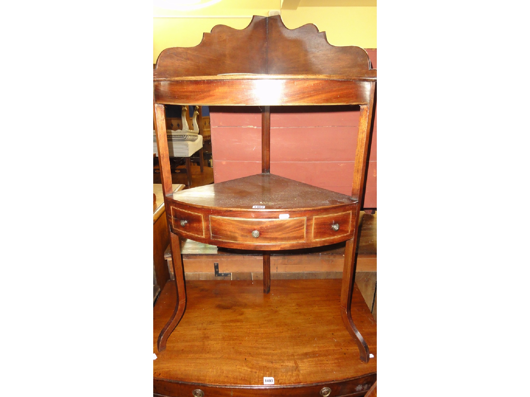 Appraisal: A Georgian mahogany corner washstand with raised and shaped splashback