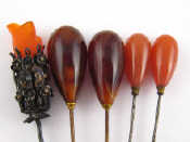 Appraisal: A mixed lot comprising two tortoise shell mounted hat pins