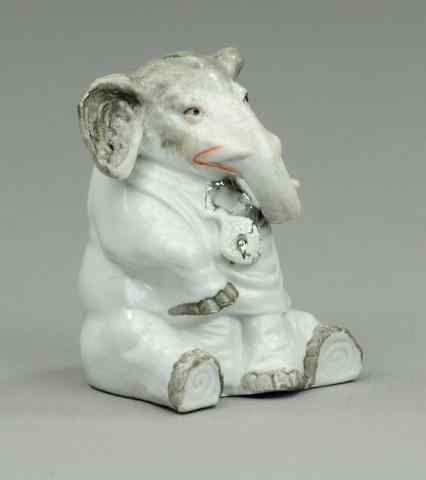 Appraisal: SEATED ELEPHANT PORCELAIN STILL BANK Germany c whimsical pose colored