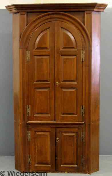 Appraisal: Pennsylvania pine two-piece architectural corner cupboard th c with raided