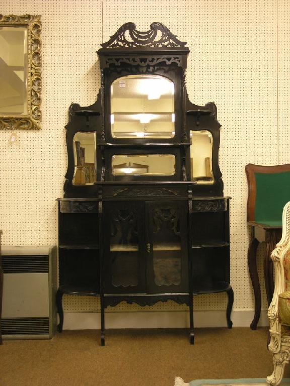 Appraisal: A late Victorian ebonised tall display cabinet elaborately carved the