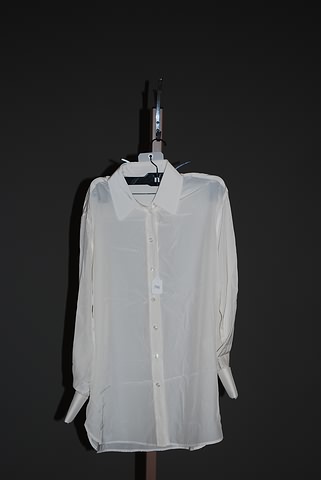 Appraisal: Yves St Laurent ivory silk long sleeve blouse button front