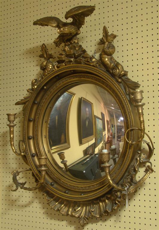 Appraisal: REGENCY STYLE GILTWOOD GIRANDOLE the convex mirror plate surmounted by