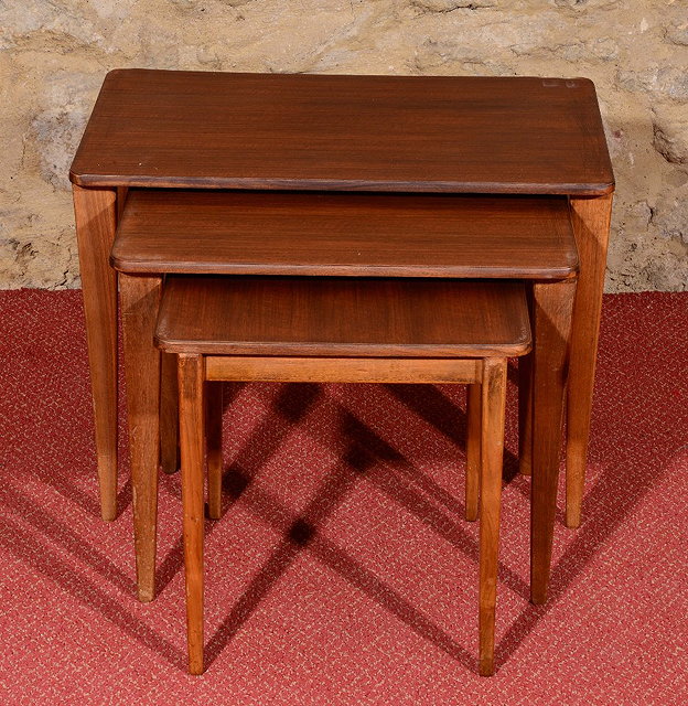 Appraisal: A NEST OF THREE GRADUATED WALNUT OCCASIONAL TABLES by Gordon