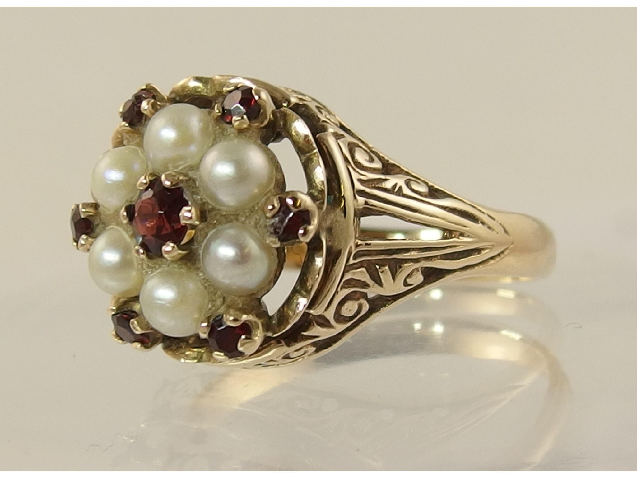 Appraisal: A ct garnet and pearl flower ring