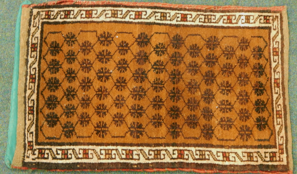 Appraisal: A Persian runner in repeat geometric floral pattern on brown