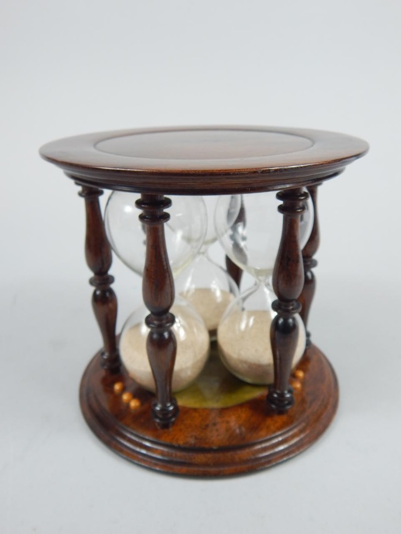 Appraisal: A modern mahogany finish three sectional egg timer with circular