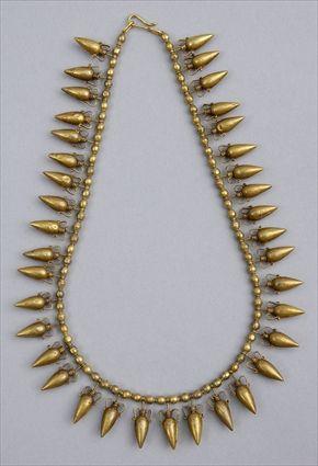 Appraisal: AMPHORA-FORM NECKLACE Strand of small hollow gold ovoid beads alternated