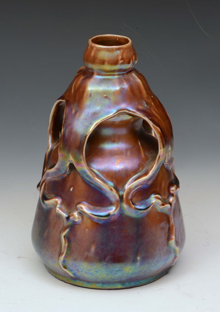 Appraisal: Manner of ZsolnayAn iridescent vase with looped handles and Art