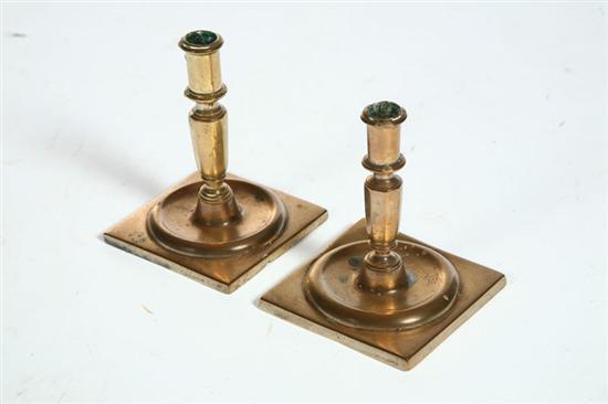 Appraisal: TWO BRASS CANDLESTICKS European th century Paneled columns with threaded