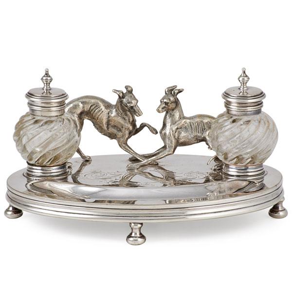 Appraisal: SILVER PLATED FIGURAL INK STAND Two hounds at play with