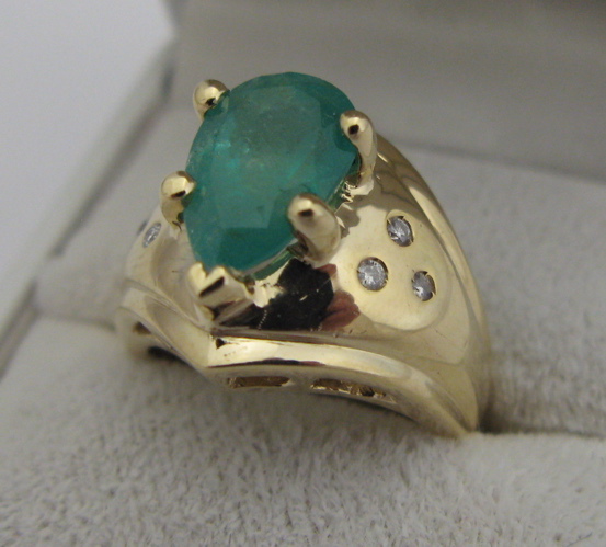 Appraisal: EMERALD DIAMOND AND KARAT GOLD RING set with a pear-cut