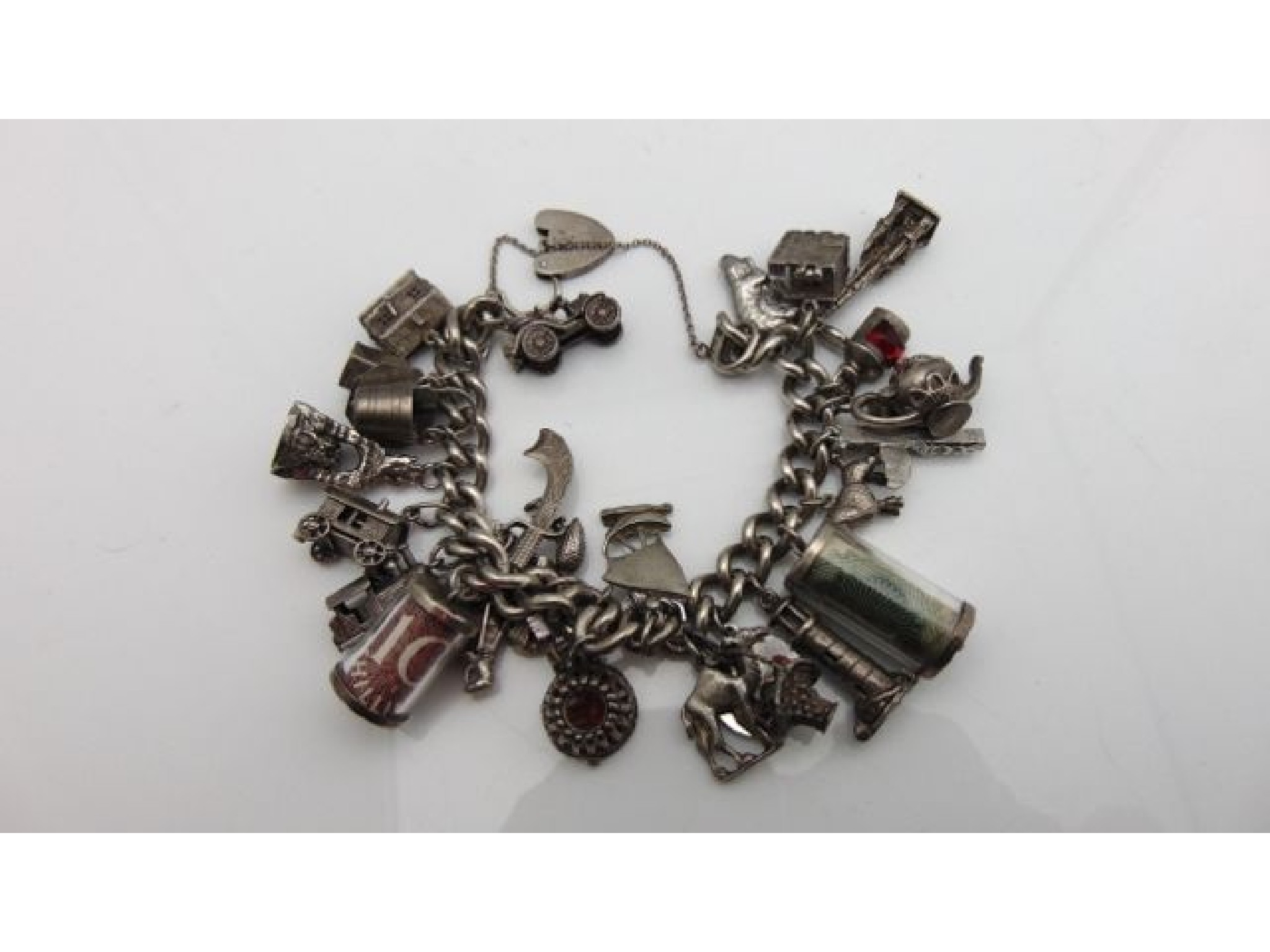 Appraisal: A sterling silver charm bracelet suspended with twenty-seven various charms