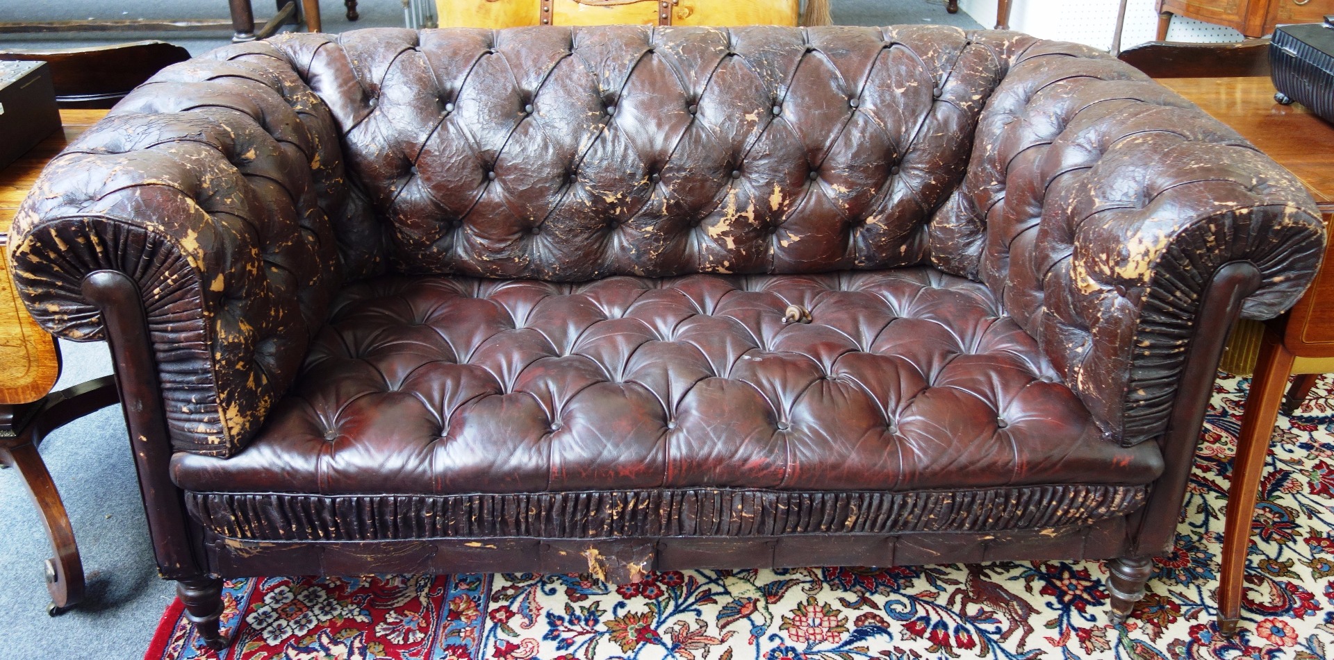 Appraisal: An early th century button back rouge leather upholstered Chesterfield