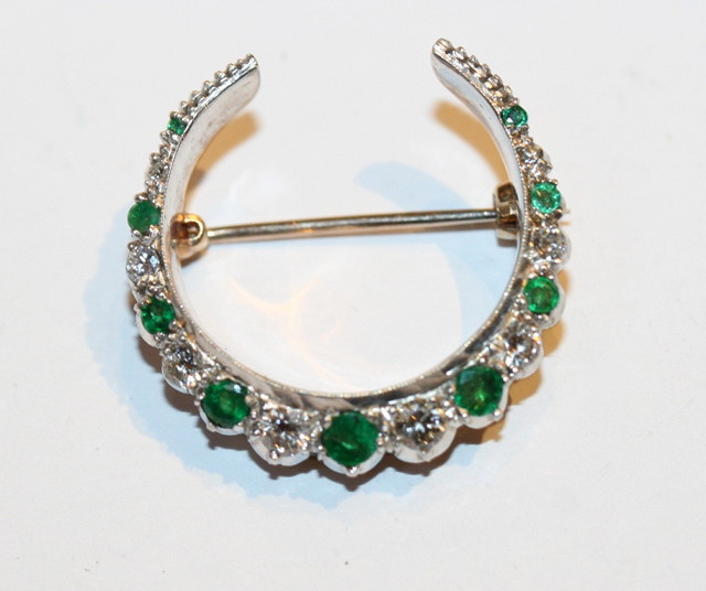 Appraisal: AN EMERALD AND DIAMOND CRESCENT BROOCH the alternating stones in