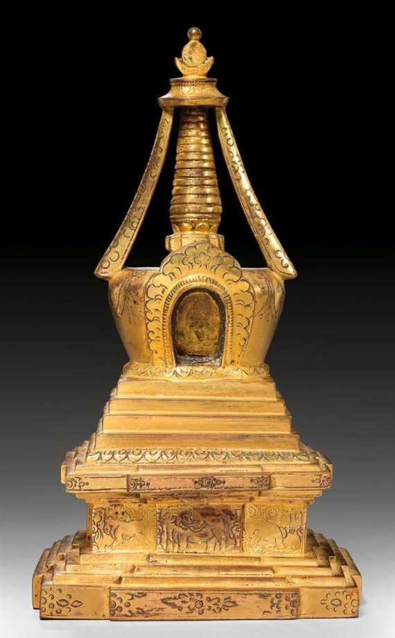 Appraisal: A GILT BRONZE STUPA HOSTING A SMALL FIGURE OF BUDDHA