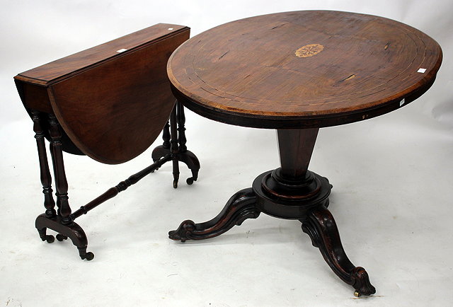 Appraisal: A VICTORIAN MAHOGANY OVAL TOPPED SUTHERLAND TABLE with turned supports