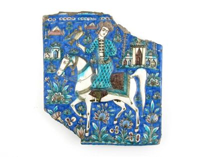 Appraisal: A Qajar tile pottery fragment moulded with an equestrian falconer