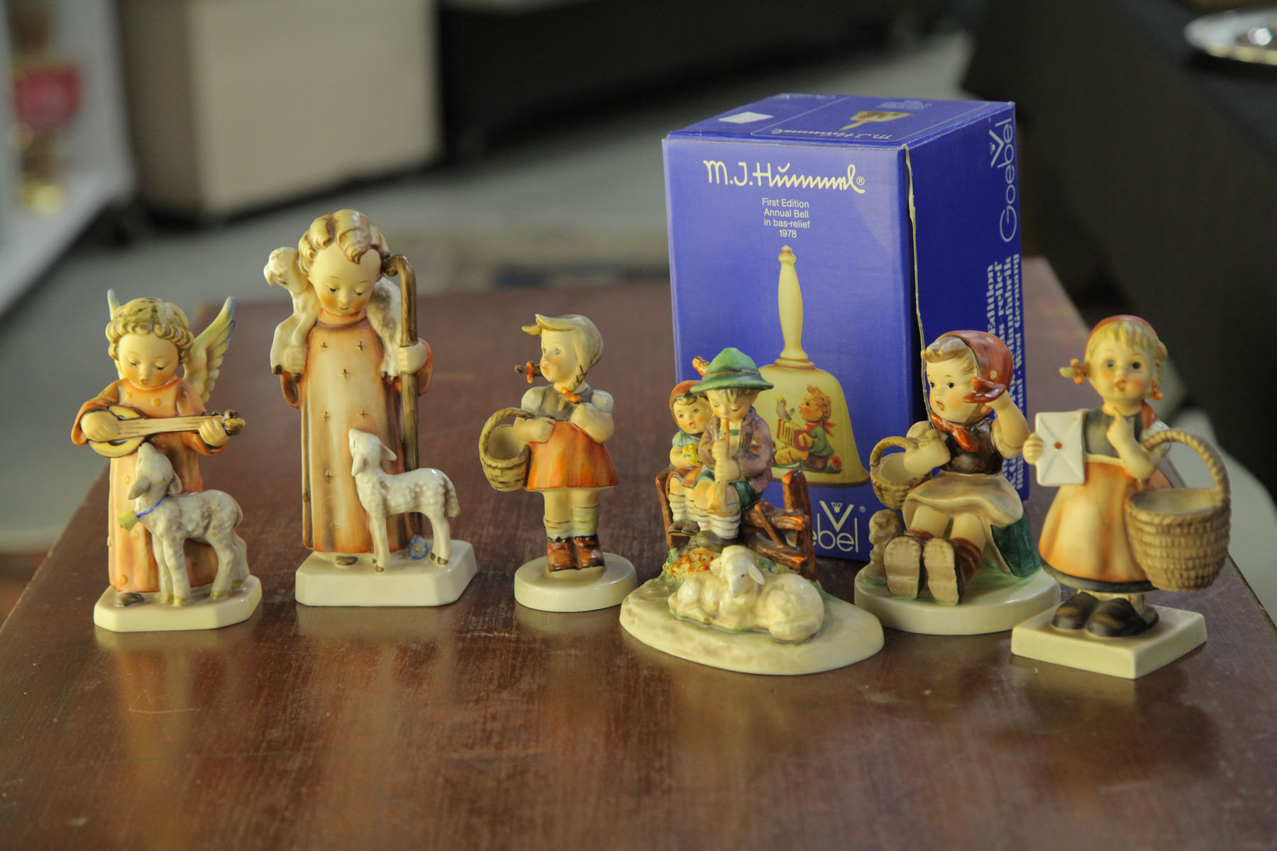 Appraisal: SIX HUMMEL FIGURINES AND A HUMMEL BELL German th century