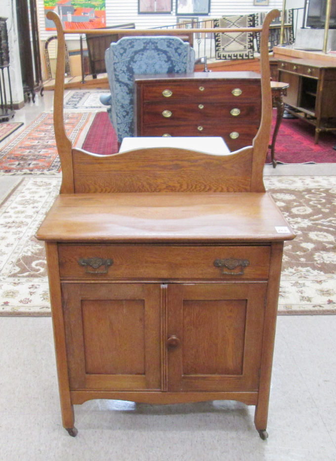 Appraisal: A LATE VICTORIAN OAK WASHSTAND American c the front with