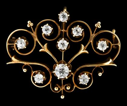 Appraisal: Low karat rose gold and diamond broochDisplays nine round cut