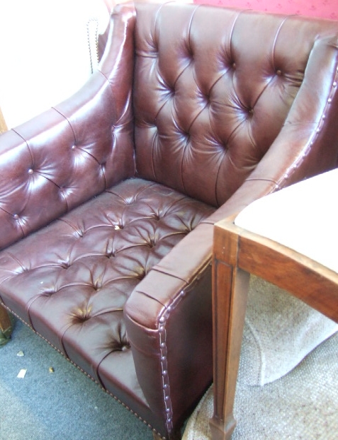 Appraisal: A Regency design leather upholstered button back armchair with brass