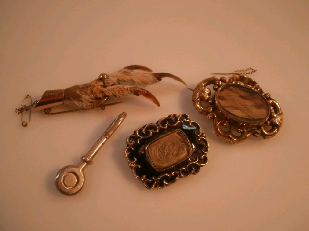 Appraisal: Two Victorian memorial brooches with hair inserts and a grouse