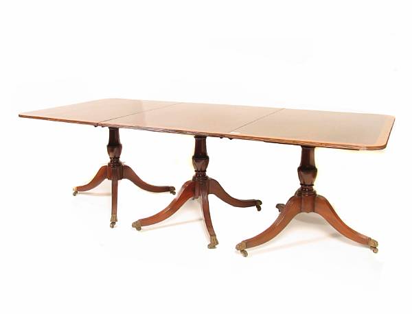 Appraisal: A Regency style three pedestal dining table with two leaves