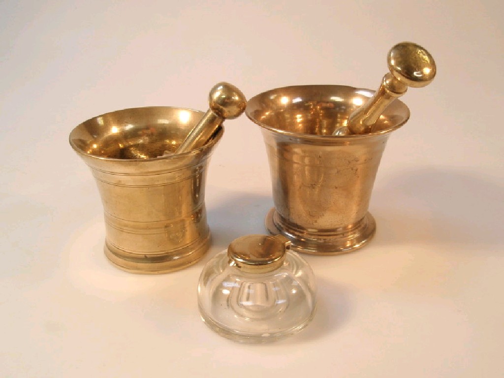 Appraisal: Two brass pestle and mortars and a glass inkwell with