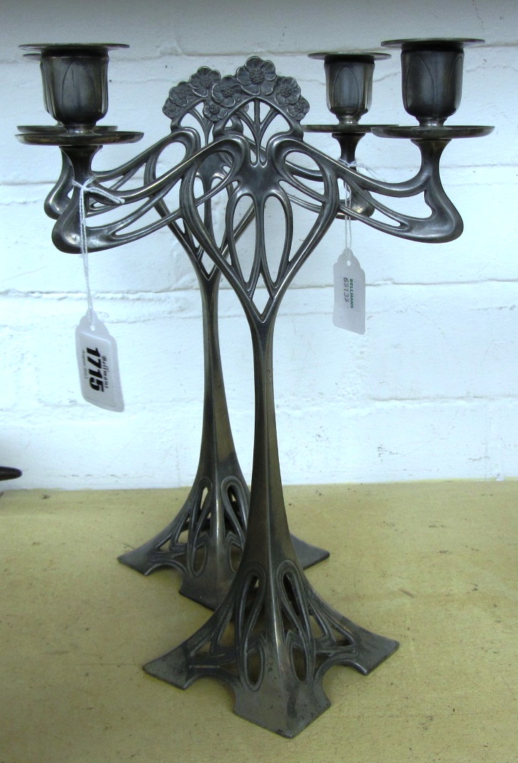 Appraisal: A pair of WMF style white metal two branch candlesticks