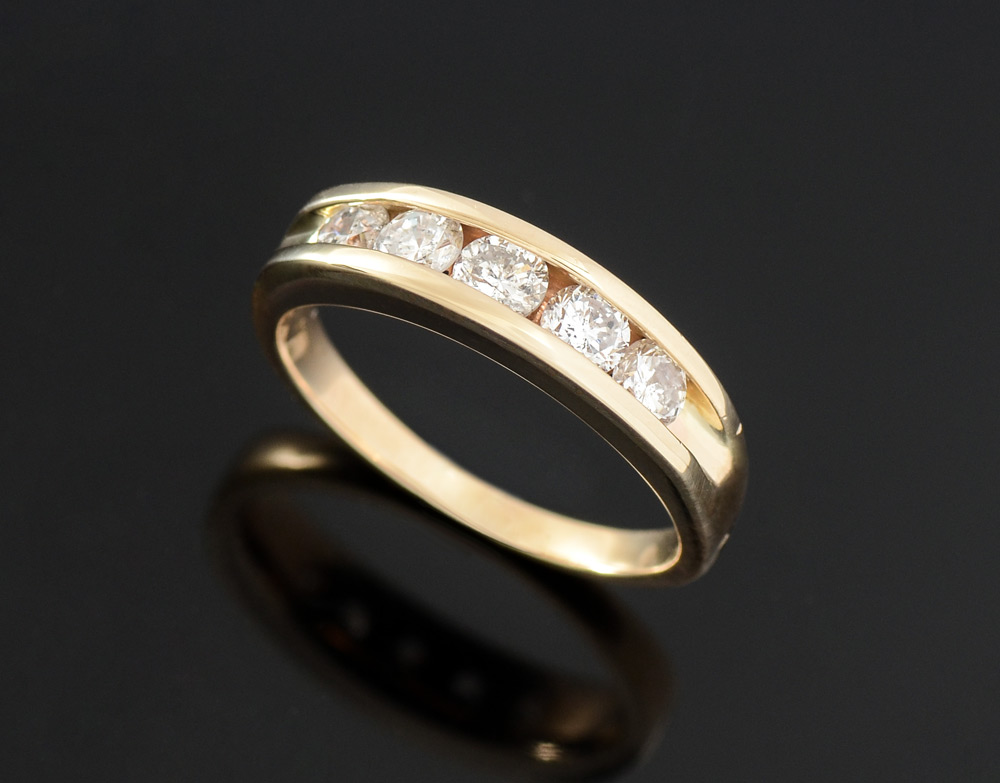 Appraisal: K CHANNEL SET WEDDING BAND Round Brilliant Cut Diamonds are