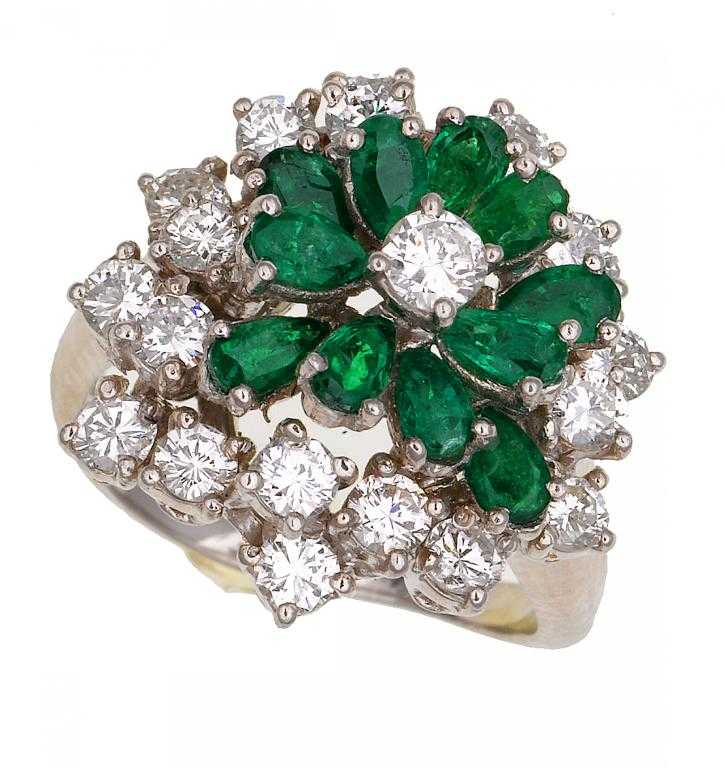 Appraisal: AN EMERALD AND DIAMOND CLUSTER RING of stylised flower design