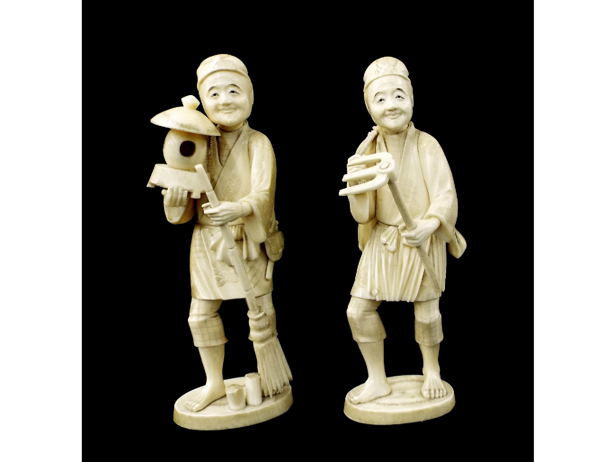 Appraisal: Pair of Japanese ivory okimono of workmen one with field