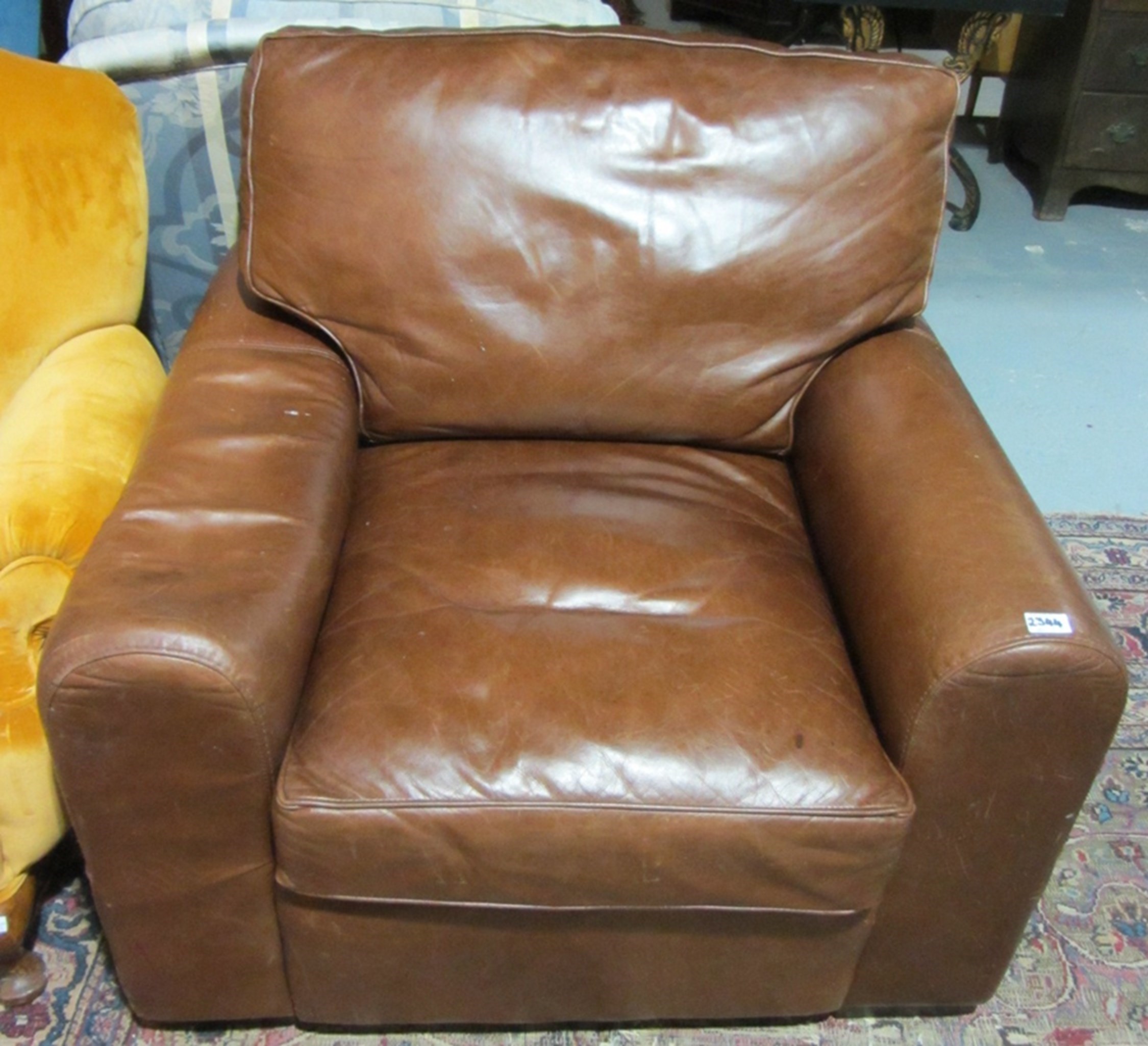 Appraisal: A th century brown leather armchair on block feet