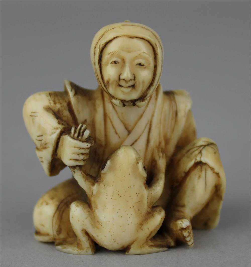 Appraisal: IVORY NETSUKE OF AN OLD LADY PLAYING WITH A TOAD