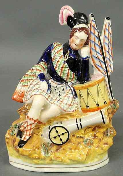 Appraisal: Staffordshire figure of a Scotsman sleeping on a drum th