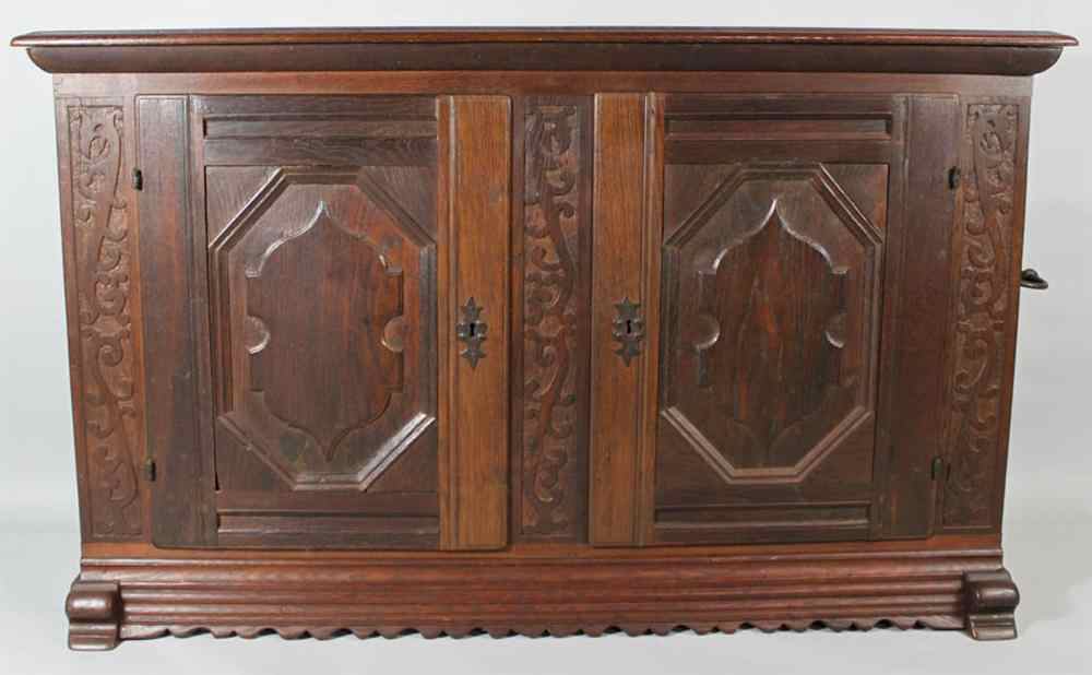 Appraisal: BAROQUE STYLE OAK SIDE CABINET the rectangular molded top over