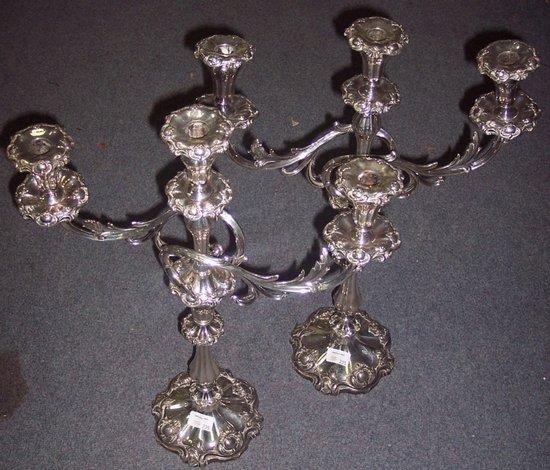 Appraisal: A pair of two-branch three-light candelabra with C scroll borders