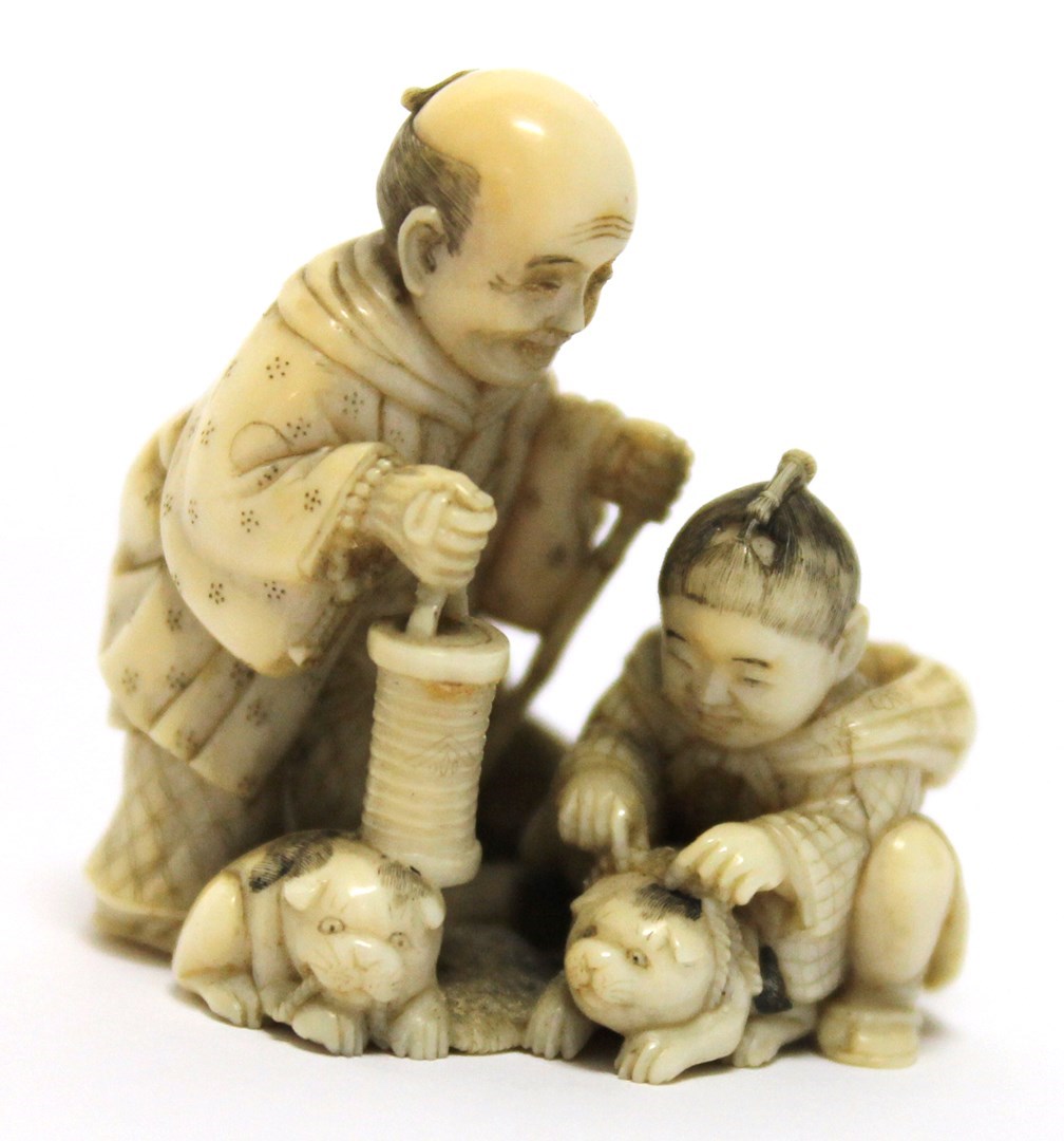 Appraisal: A Japanese ivory netsuke Meiji period carved as a man