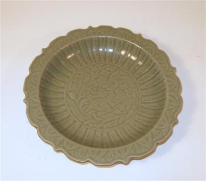 Appraisal: Chinese Ming-style carved celadon dishOf organic foliate form with bracket